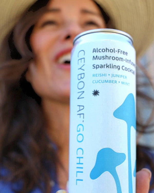 Person holding a can of 'Ceylon Af Go Chill' sparkling water with a straw.